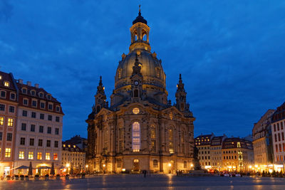 Low angle view of illuminated buildings against sky at night