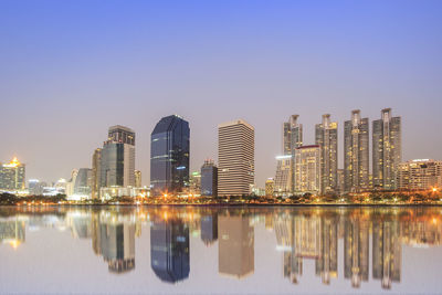 Reflection of buildings in city against sky