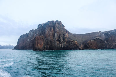 Scenic view of sea and mountains against sky