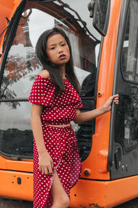 Full length of woman standing in car