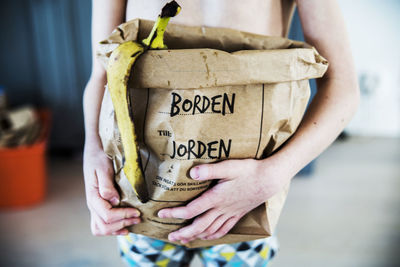 Person holding bag with food waste