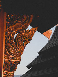 Low angle view of statue against building in city