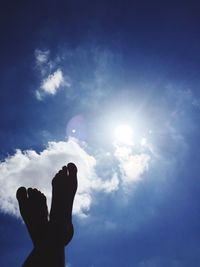 Low angle view of silhouette hand against sky