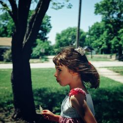 Side view of a girl drinking from park