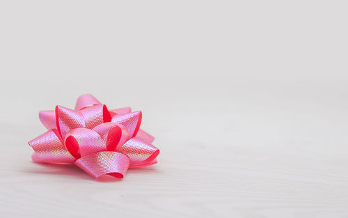 Close-up of heart shape on table against white background