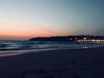 Scenic view of sea against clear sky at sunset