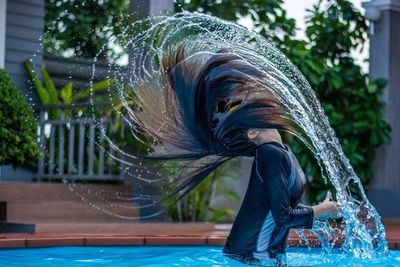 Full length of young woman in swimming pool