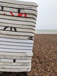 Stack of stones on beach against clear sky