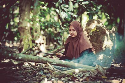 Woman sitting in forest