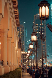 Low angle view of illuminated street lights at night