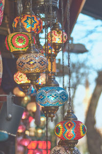 Illuminated lanterns hanging at market stall