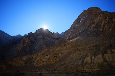 Scenic view of mountains against clear blue sky