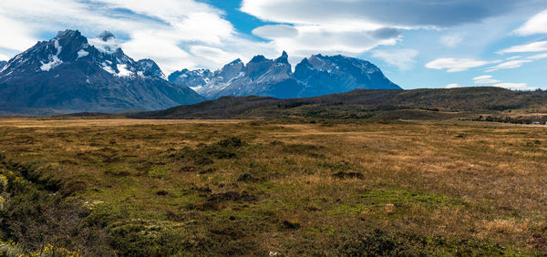 Scenic view of mountains against cloudy sky