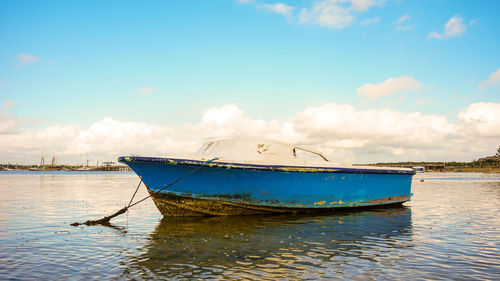 Fishing boat in sea against sky