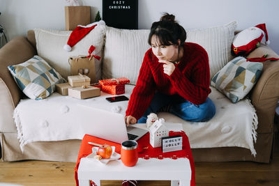 Rear view of woman using mobile phone