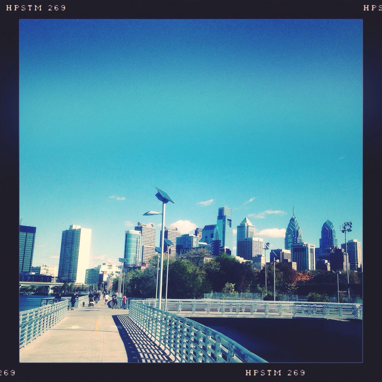 building exterior, city, architecture, built structure, transfer print, blue, skyscraper, auto post production filter, cityscape, city life, clear sky, sky, office building, street light, railing, modern, tower, tall - high, street, urban skyline