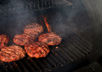 High angle view of meat on barbecue grill