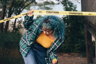 Woman standing by text on plant