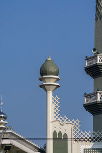 Low angle view of buildings against blue sky