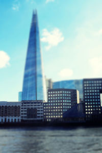 View of skyscrapers against cloudy sky