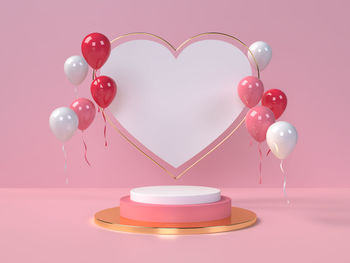Digital composite image of heart shape on pink table against gray background