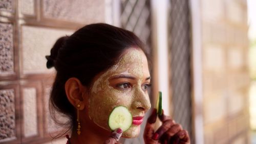 Close-up of young woman eating food