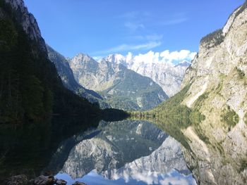 Scenic view of lake and mountains against sky