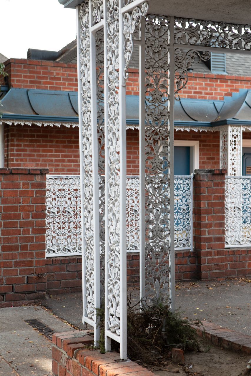 architecture, built structure, building exterior, building, no people, day, brick wall, outdoors, wall, staircase, house, brick, architectural column, focus on foreground, wall - building feature, place of worship, belief, entrance, nature, religion