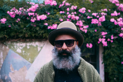 Portrait of fancy bearded man wearing hat and sunglasses