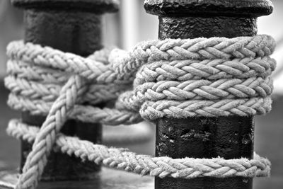 Close-up of ropes tied up on bollards