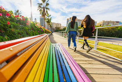 Women walking on walkway in city