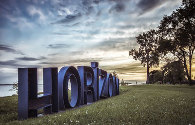 Trees on landscape against sky