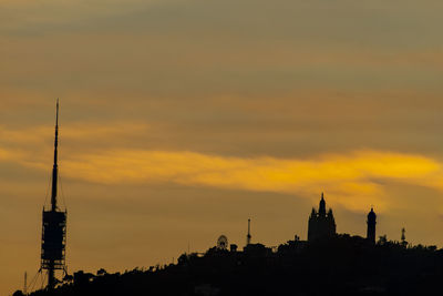 Low angle view of buildings against sky during sunset