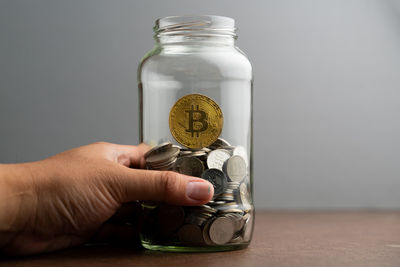 Person holding glass jar