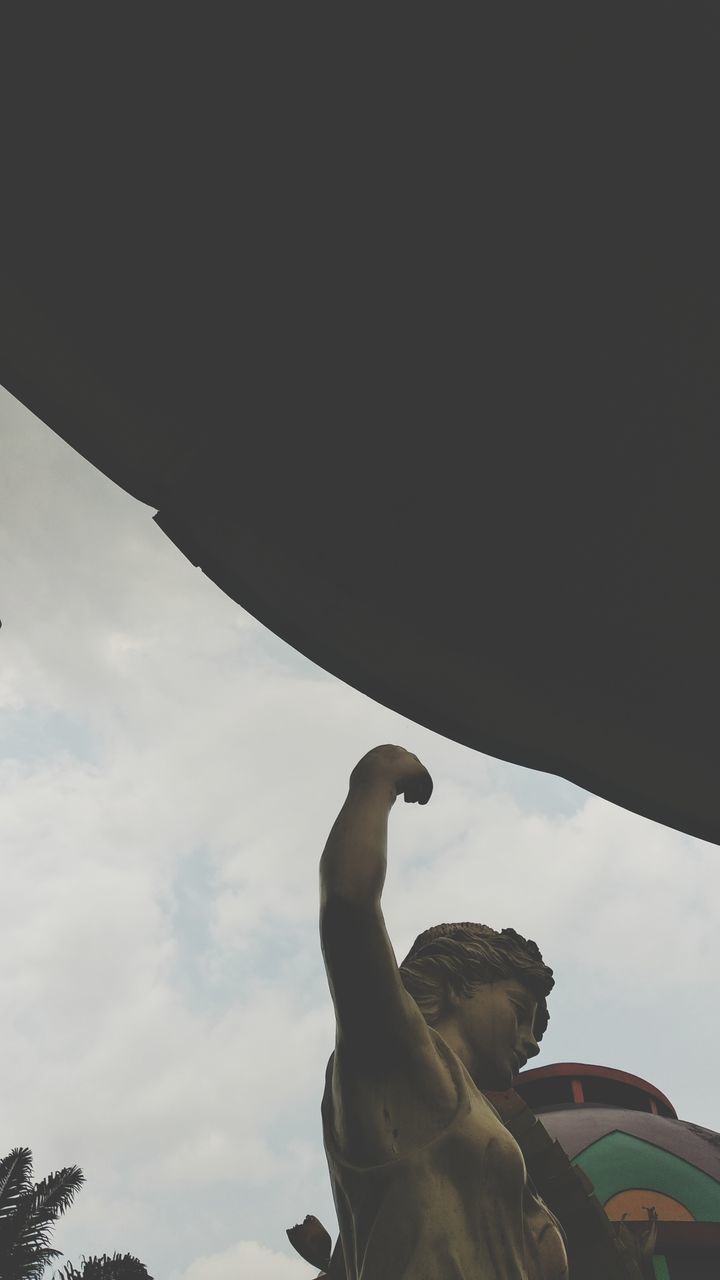 LOW ANGLE VIEW OF STATUE AGAINST SKY AND CLOUDS