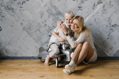 Woman sitting on wooden floor