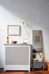 Radiator with lamp wood objects, picture frames