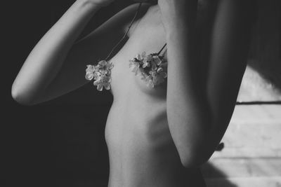 Close-up of woman hand on pink flower