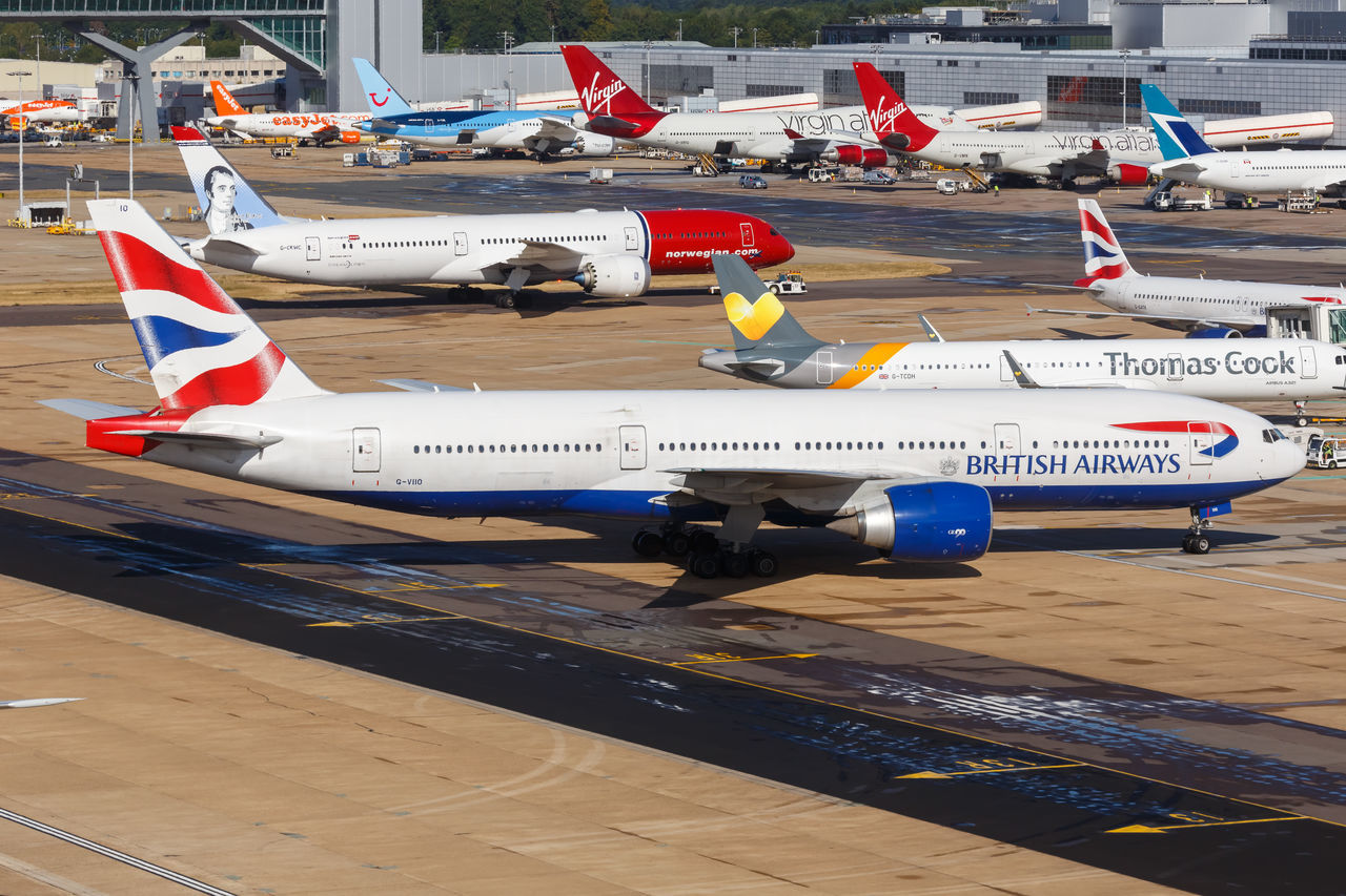 HIGH ANGLE VIEW OF AIRPLANE AT AIRPORT RUNWAY