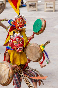 People wearing mask dancing outdoors