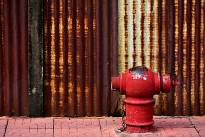 Close-up of fire hydrant against wall