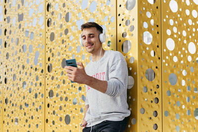 Portrait of young man using mobile phone