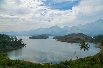 Scenic view of lake and mountains against sky