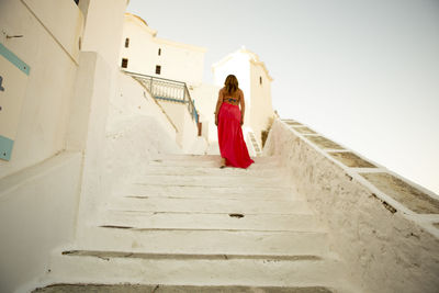 Rear view of woman walking on staircase