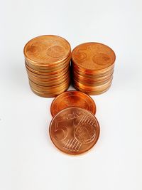 High angle view of coins on white background