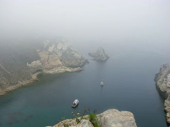 High angle view of sea by rocks