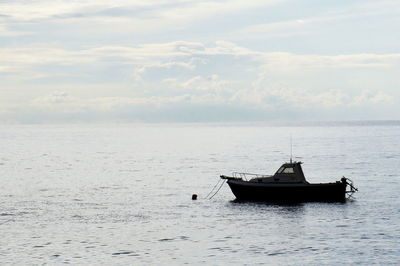 Boat sailing in sea against sky