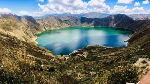 Scenic view of lake and mountains against sky