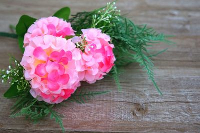 Close-up of pink rose on table