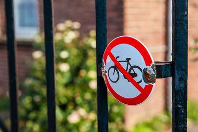 Close-up of warning sign on metal gate